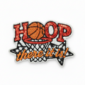 A decorative embroidered patch with the word "HOOP" in red letters, a basketball inside a net, and the phrase "there it is!" in orange script on a black star-shaped outline with a silver glitter border.