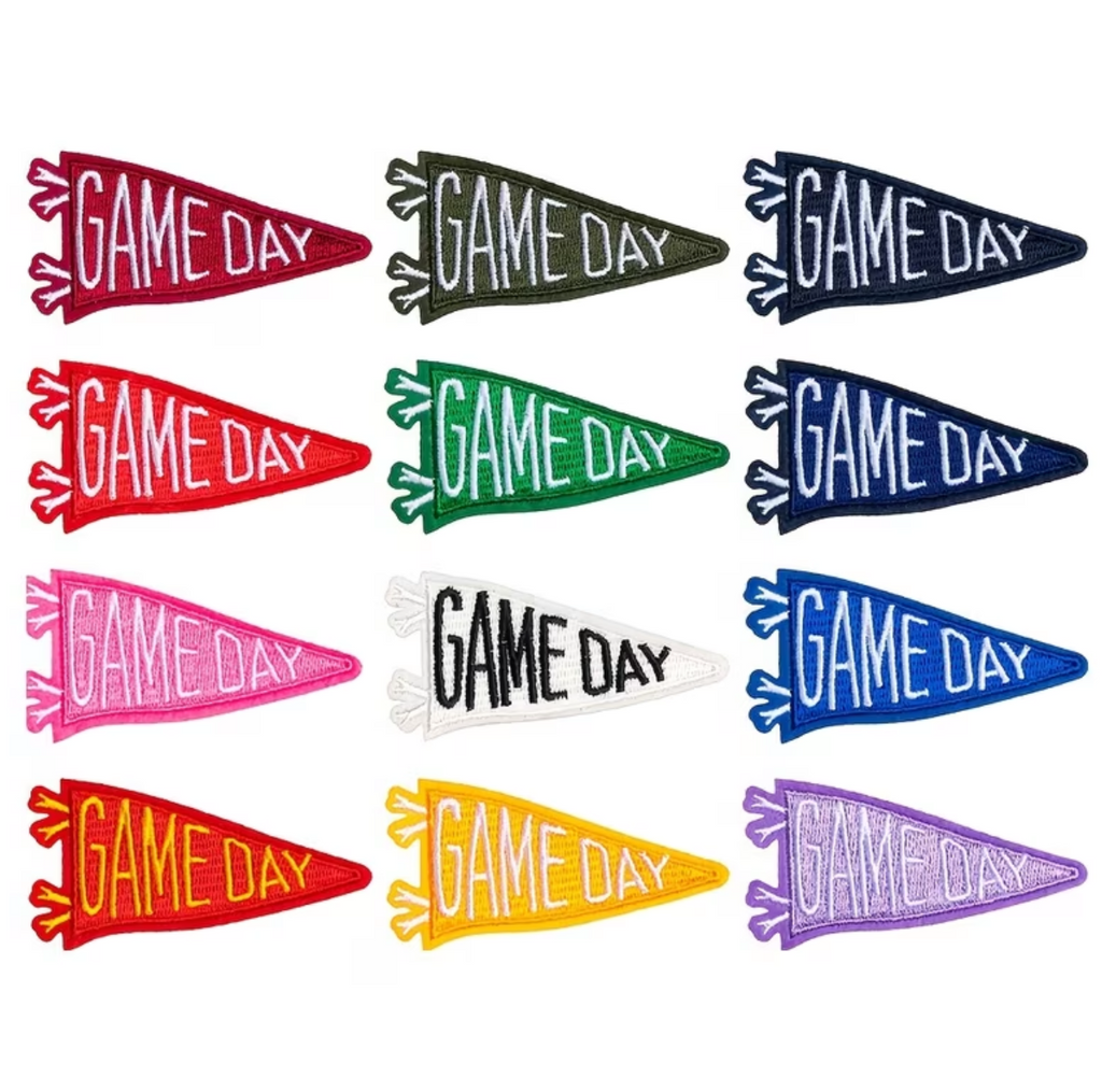 A grid of 15 mini scarves, each 3x5 inches, in various colors including navy, blue, purple, green, white, yellow, red, and pink. Each scarf features 'GAME DAY' embroidered in white across the front and finished with tassel fringe on the bottom.