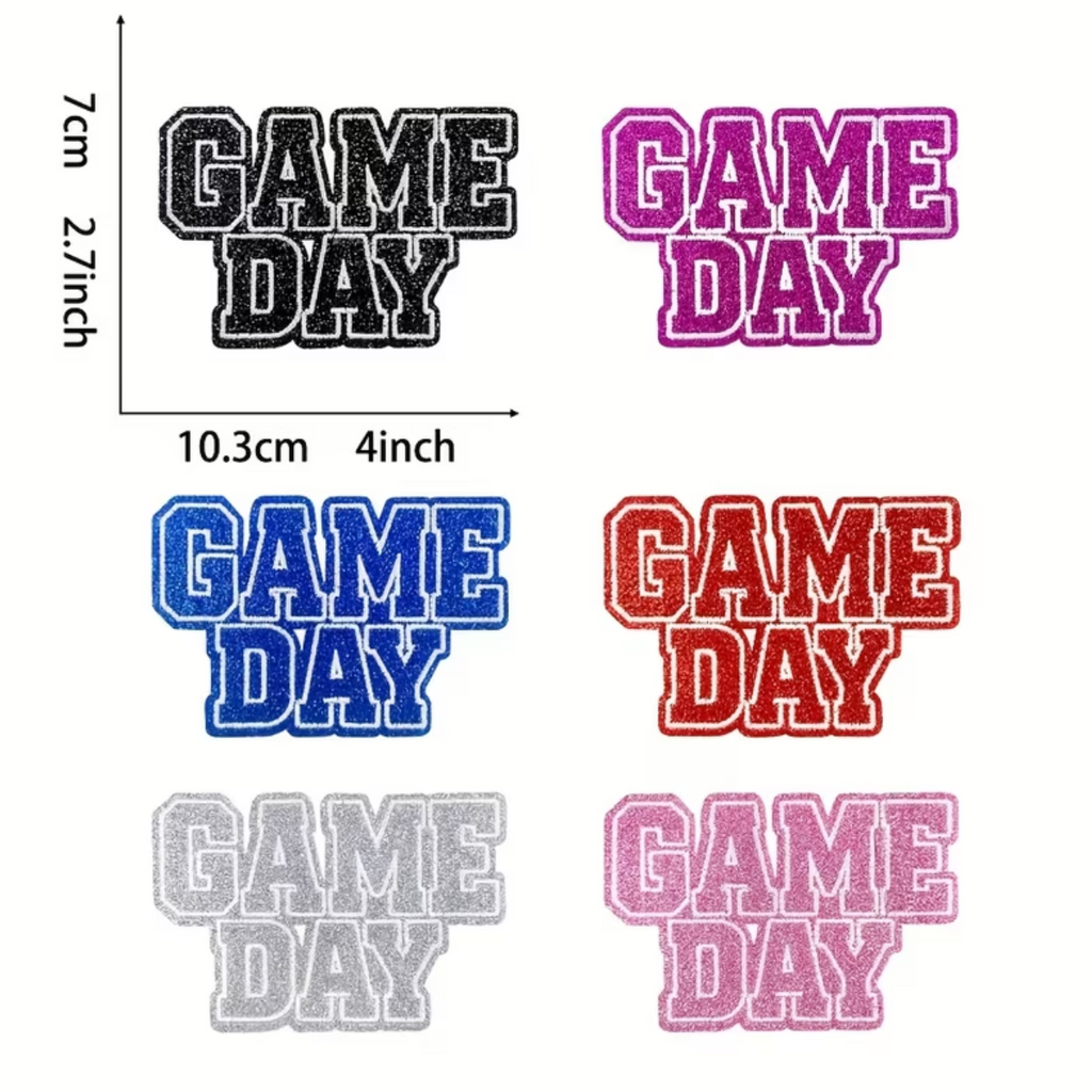 A size and color reference graphic for 'GAME DAY' embroidered patches, showing six color options (black, pink, blue, red, light gray, and pink) with dimensions of 7cm by 10.3cm (2.