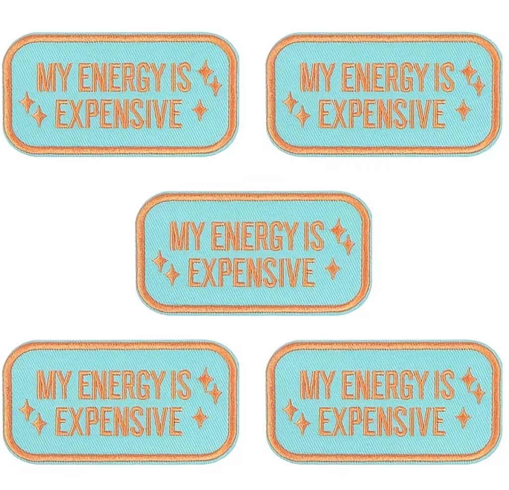 Five identical rectangular stickers with rounded corners displayed on a white background. Each sticker has a light blue center with the text 'MY ENERGY IS EXPENSIVE' in orange, surrounded by a thin orange border and small orange sparkles.