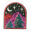 An arched embroidered patch featuring a mountain landscape with pine trees under a night sky with a crescent moon and stars. The mountains are split between red on the left and purple on the right, with teal trees and a black starry sky.